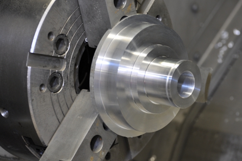 block of aluminum on lathe being machined